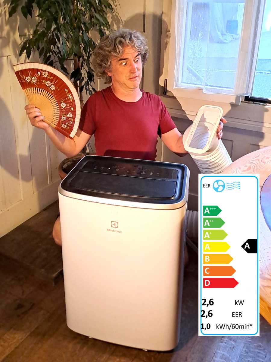 Samuel, Autor of Calcumber doubtfully inspects the exhaust tube of a portable air conditioner.